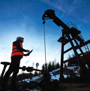 oil & gas worker evaluating rig equipment